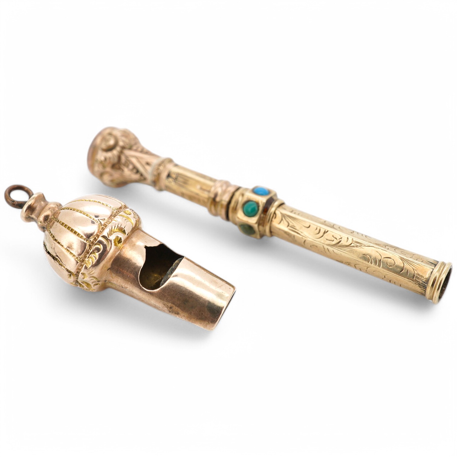An early 20th century engraved yellow metal, citrine and turquoise set propelling pencil (turquoise stone missing), 42mm, together with a yellow metal whistle charm. Condition poor to fair